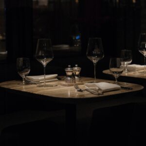 Sophisticated table setup in a New York restaurant, with wine glasses and cutlery, ready for a gourmet experience.