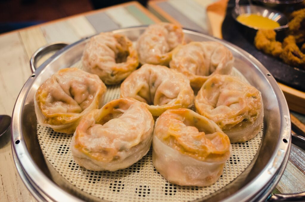 Close-up of mouthwatering steamed dumplings served on a tray. Perfect for Asian cuisine lovers.