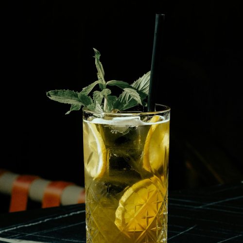 Chilled lemon mint cocktail in a crystal glass, perfect for refreshing on a hot day.
